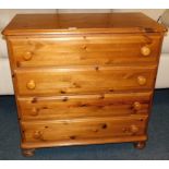 A pine chest, of four long drawers, raised on bun feet, 85cm high, 83cm wide, 43cm deep.