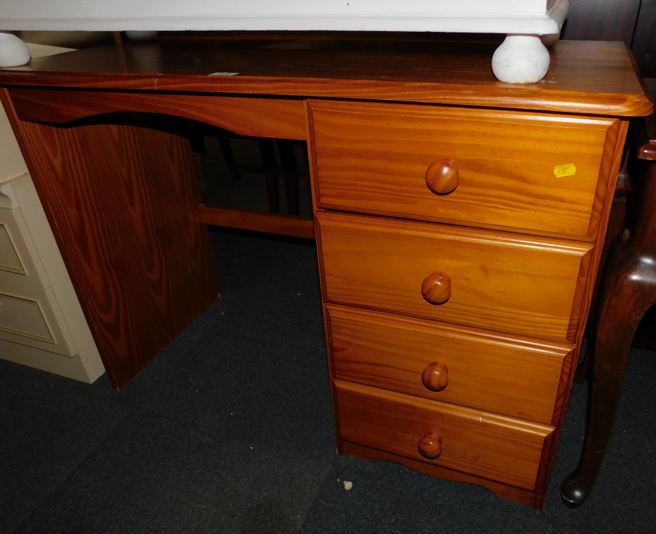 A pine dressing table, with four drawers, 76cm high, 106cm wide, 49cm deep.