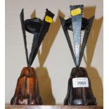 A pair of modernistic cast iron and wooden candlesticks.