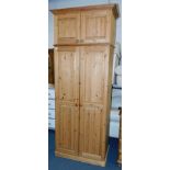 A Beverley Owen pine two door wardrobe, with cupboards below, 184cm high, 85cm wide, 52cm deep.