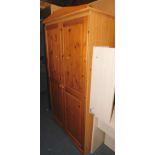 A pine and pine effect double wardrobe, 183cm high, 97cm wide, 54cm deep.