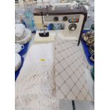 A Jones electric sewing machine, model VX710, lead lacking, together with a cream floral bed throw.