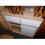 A 1960's painted kitchen counter with two drawers, curved end shelves and two sliding doors, 85cm