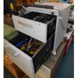 A metal two drawer trolley tool chest, containing spanners, hammers, wrenches and other tools.