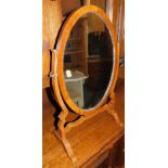 An early 20thC mahogany framed toilet mirror, with oval plate, 54cm high.