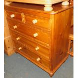 A pine chest of two over three drawers, raised on turned feet, 99cm high, 102cm wide, 48cm deep.
