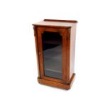 A Victorian walnut and inlaid music cabinet, the glazed door opening to reveal three shelves, raised
