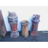 Three terracotta chimney pots, comprising two brown glazed pots and a stoneware chimney pot, 110cm
