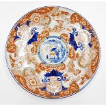 A Japanese porcelain Imari charger, decorated in red, orange, green and underglaze blue palette with