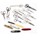 Various pen knifes, scissors, etc., a part silver handled manicure set with cherub handles,