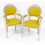 A pair of modern French style armed chairs, with padded back and seats