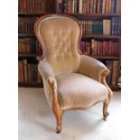 A Victorian mahogany show frame armchair, upholstered in button beige fabric, on cabriole legs