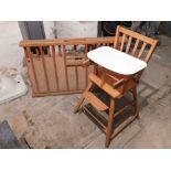 A folding wooden cot and child's high chair. (2)