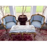 A pair of Louis XV style French gilt wood and gesso fauteuils, each with a moulded show frame,