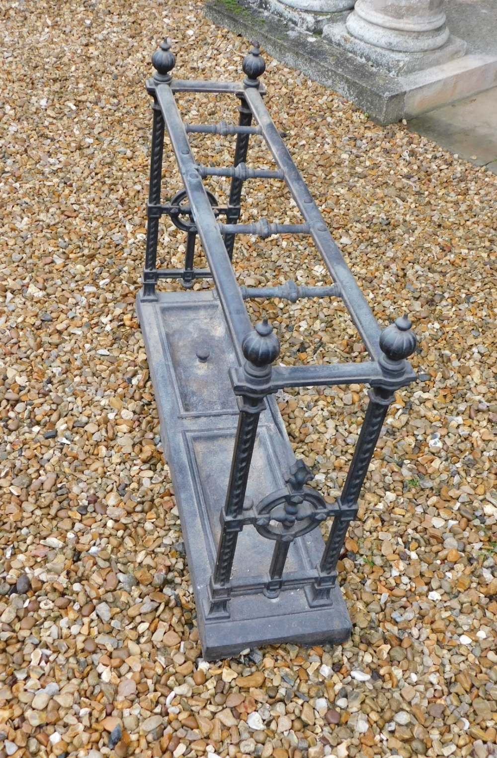 A Victorian cast iron umbrella stand, with five divisions, on spiral end supports, headed by - Image 2 of 2