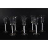 A set of eight 18thC wine glasses, with plain trumpet shaped bowls, on double opaque twist stems and