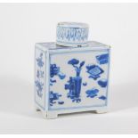 An 18thC blue and white porcelain tea canister and cover, decorated with vases and flowers, 12cm