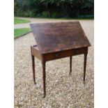 A late George III mahogany reading or folio table, the rectangular top with a crossbanded border and