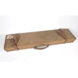 A vintage Westley Richards and Co canvas bound gun case, with leather straps and handle, bears the