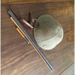 A British Army First World War period tin helmet, and canvas cover, and a swagger stick for the