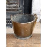 A Victorian copper coal bucket of tapering form, with looped handles, 40cm diameter.