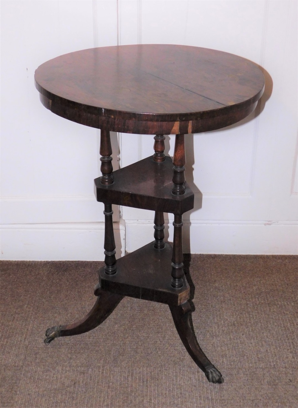 A early Victorian rosewood washstand, the circular top above two triangle undertiers, each with