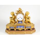 A 19thC French ormolu and Paris porcelain figural mantel clock, with enamel dial marked Howell &