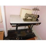 A Brother treadle tabled electric industrial sewing machine.