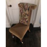 A Victorian walnut prie dieu chair, with a floral wool work back upholstered in brown fabric, on