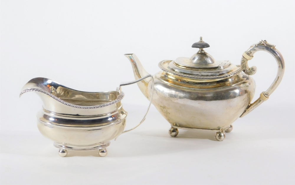 A late Victorian silver teapot, with swollen tapered body and flanged gadrooned border, leaf