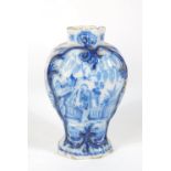 A Dutch Delft blue and white vase, c1800, decorated with continental figures, 20cm high.