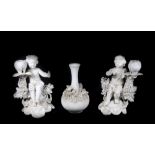 A pair of Derby white candlesticks, of cherubs holding a sconce on a shell base, 19cm high, with a