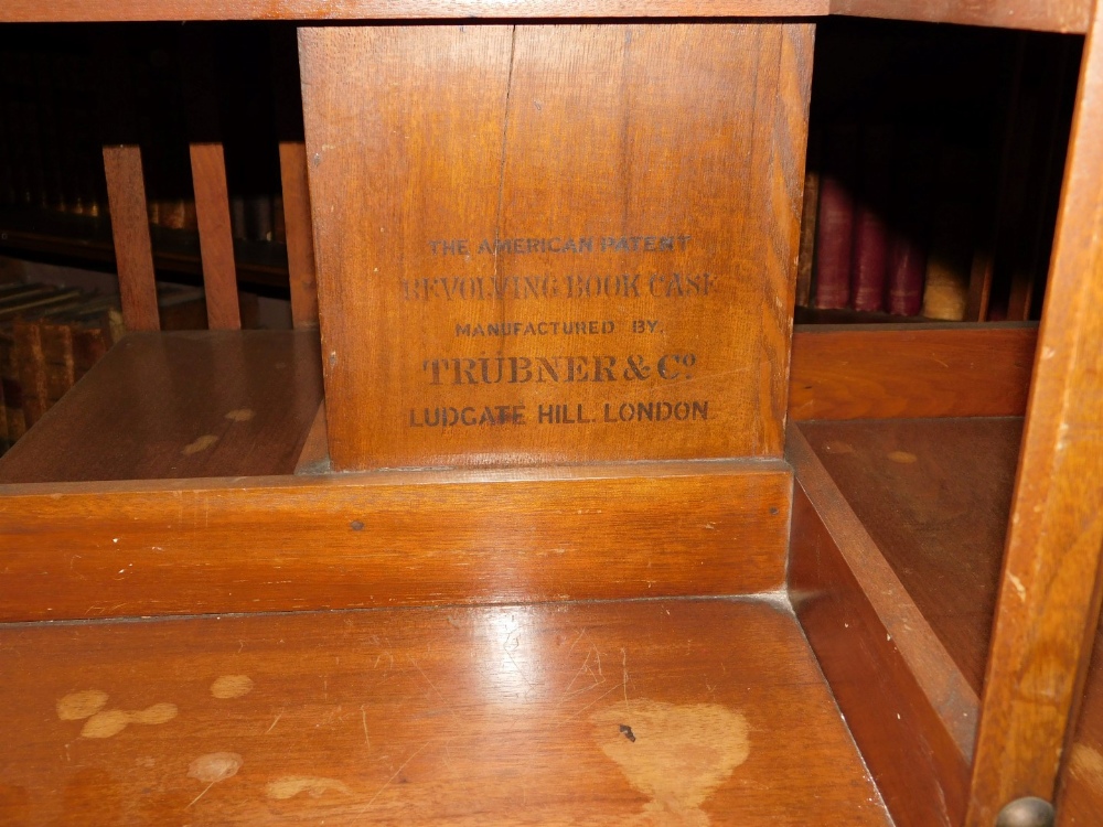 A Edwardian mahogany revolving bookcase, with slatted supports on X shaped base with ceramic - Image 3 of 3