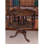 A mahogany revolving bookcase, the hexagonal top with a raised moulded gallery on reeded column