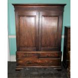 A George III mahogany clothes press, the top with moulded cornice above a blind fret carved