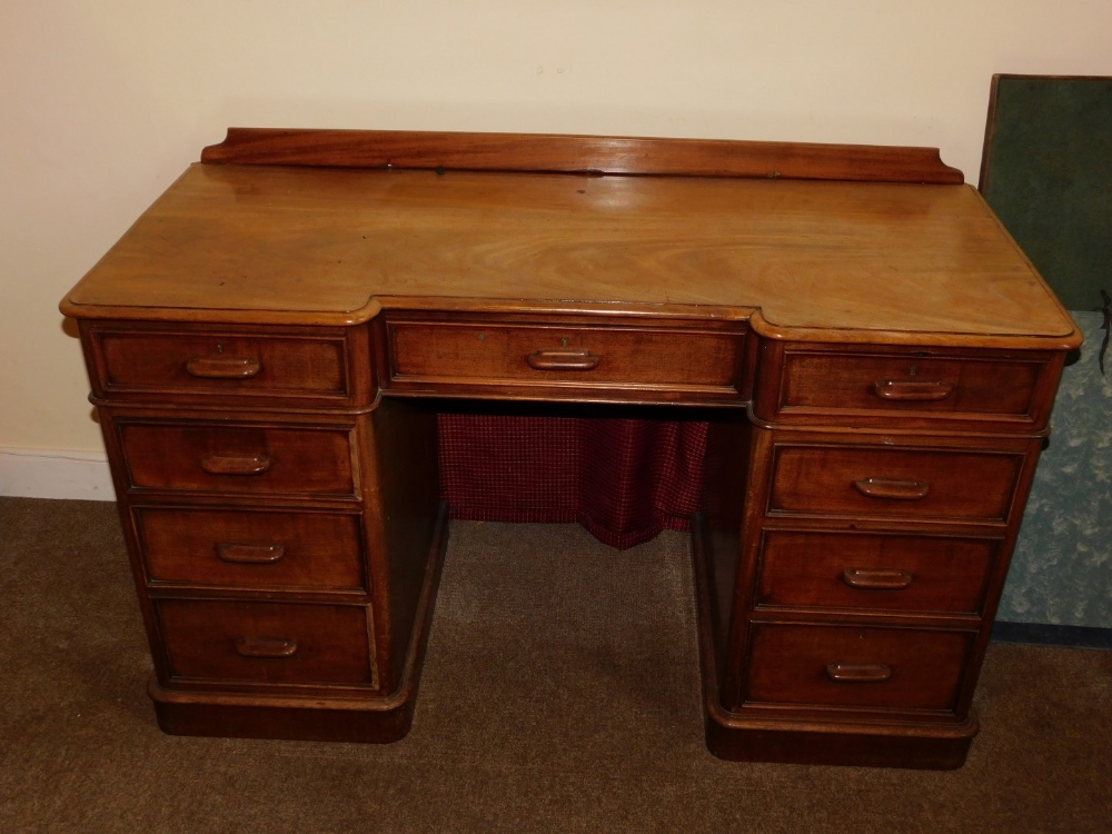 A Victorian mahogany pedestal desk, of inverted breakfront form, with a raised back, the top with