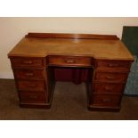 A Victorian mahogany pedestal desk, of inverted breakfront form, with a raised back, the top with