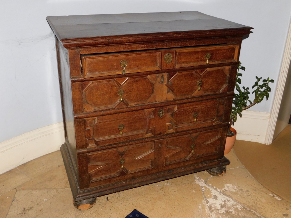 A late 17th/early 18thC oak chest of drawers, the planked top with a moulded edge, above four