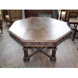 A Victorian Gothic oak library table, the octagonal planked top with a moulded edge above an