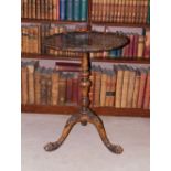 A mahogany occasional table, the circular dished pie crust top, on a turned column and tripod