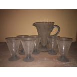 A 1930's glass lemonade set, comprising six tapered crazed conical glasses with blue feet and a