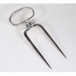 A silver plated two pronged ham fork, with loop handle.