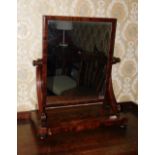 A Victorian flamed mahogany swing framed dressing table mirror, with a rectangular plate, scroll