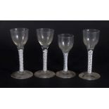Four similar 18thC wine glasses, with plain bowls and double opaque twisted stems, raised on