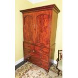 A Victorian mahogany clothes press, the top with a moulded cornice above two arched panelled doors