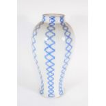 A 19thC blue and white moulded baluster vase, with painted trail decoration, 40cm high.