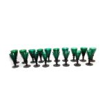 A set of eighteen Victorian green conical glasses, with knopped stems and plain circular feet,