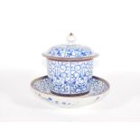 A Worcester sucrere and cover with saucer, blue floral decoration with gilt borders, 14cm high.