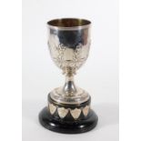 A Victorian silver prize cup, of goblet shape embossed with flowers and foliage above feather