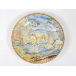 A majolica istoriato plate, depicting a tethered horse by a trough and male figure to border,